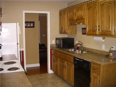 Kitchen offers lots of custom cabinets, ceramic tile the range and refrigerator remain