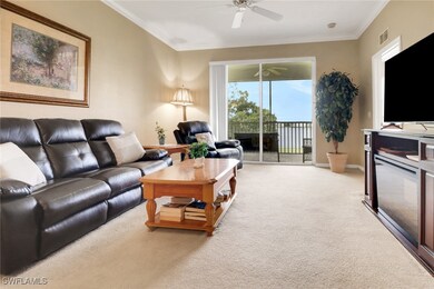 Carpeted living room with ceiling fan, ornamental