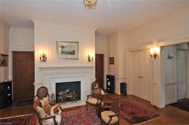 Foyer with fireplace leading into library