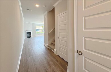 Hallway with baseboards, recessed lighting, stairw