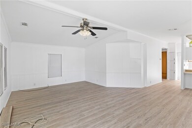 Spacious and sun-filled living area with vaulted c