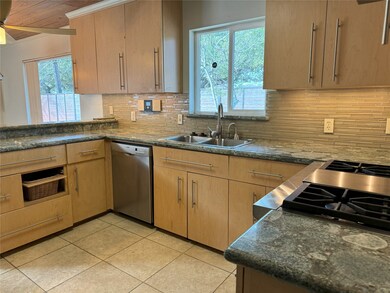 Custom cabinets, granite countertop and mosaic bac