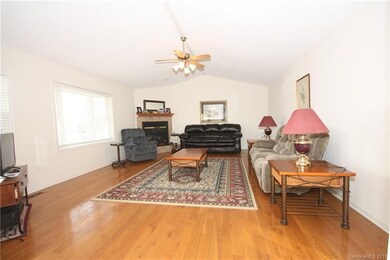 Wide-plank hardwood floors throughout the house. V