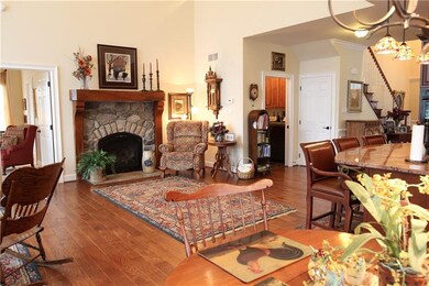 Cozy stone gas fireplace with custom mantel graces