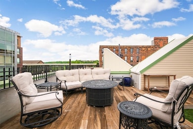Deck featuring an outdoor living space with a fire