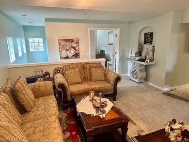 Carpeted living area with baseboards