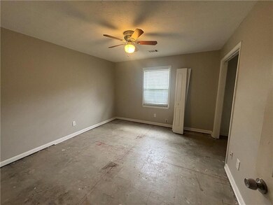 Unfurnished bedroom featuring baseboards, a textur