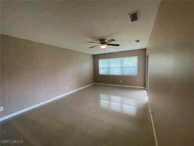 Tiled spare room with ceiling fan