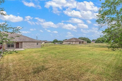 View of yard with a rural view and fence