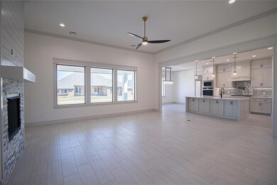 Unfurnished living room featuring ceiling fan, cro