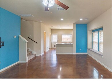 Unfurnished living room with finished concrete fl