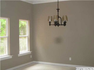 Dining area with stylish light fixture. This room 