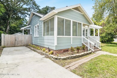 Long driveway leading to gate and garage