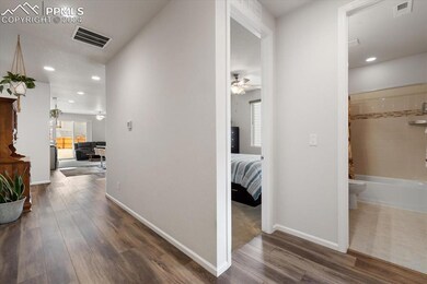 Corridor with dark hardwood / wood-style flooring