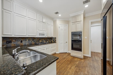 Kitchen is equipped with granite countertops, walk