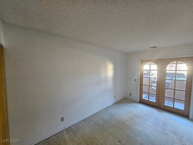 Carpeted empty room featuring visible vents and a