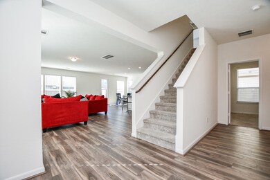 The beauty and versatility of the open floor plan design concept is immediately appreciated in the tremendous amount of room you have in your living/family area, left, and beyond to the kitchen and bright breakfast area.