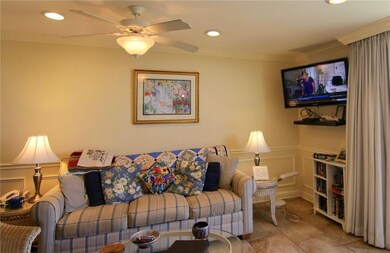 Living Room with ceiling fan and wall mounted TV