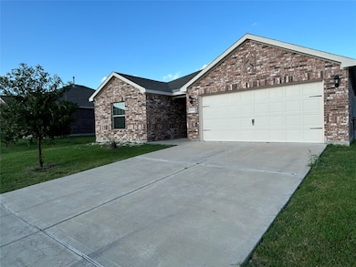 Ranch-style home with brick siding, a front lawn, concrete driveway, and a garage