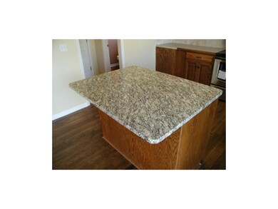 New granite countertop with 2-seat breakfast bar.