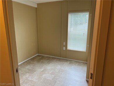 Empty room featuring light colored carpet