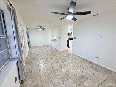 Spare room featuring a ceiling fan and light tile patterned floors