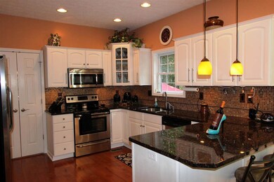 The kitchen features crown-topped cabinetry, stain