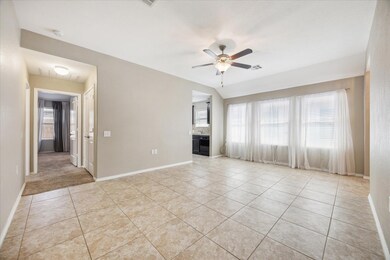 Unfurnished living room featuring light tile patt