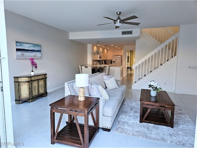 Living room with light tile patterned floors and c