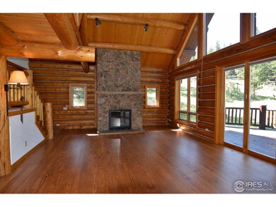 Wood floors and moss rock fireplace