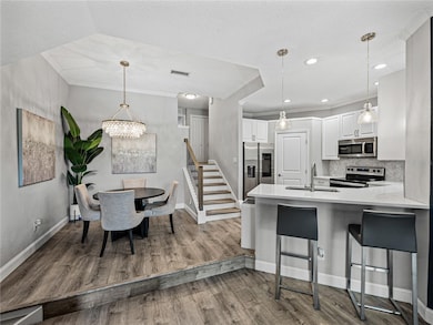 Kitchen with Stone Countertops, Wood Cabinetry + Bar