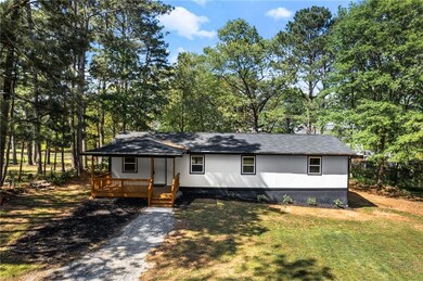 View of front of house with a shingled roof and a front yard