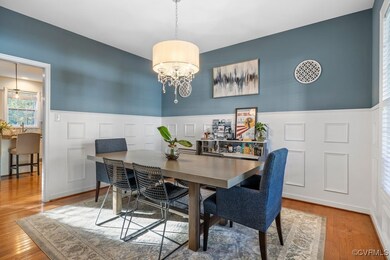 Dining room featuring a notable chandelier and woo