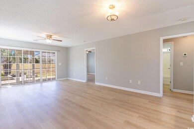 Empty room with baseboards, light wood-style floor