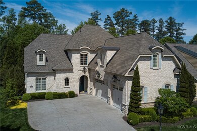 French country style house featuring a garage, dri