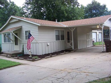 Carport attached to garage with a side entrance do