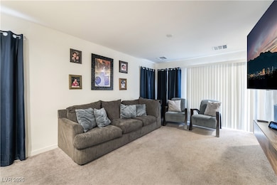 Living area with visible vents and carpet floors