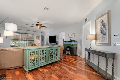 Living area with wood finished floors and a ceiling fan