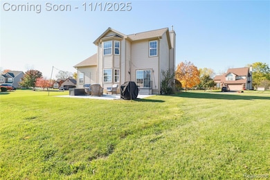 Back of property with a lawn, a chimney, a patio area, and a residential view
