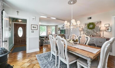 Dining room with wood flooring opens to Living Roo