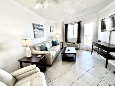 Living room featuring a textured ceiling, cooling 