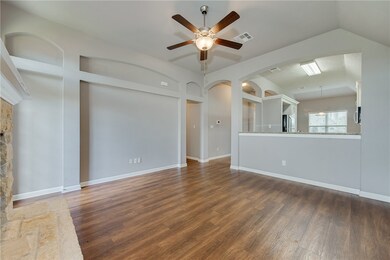 Unfurnished living room with a ceiling fan, wood f