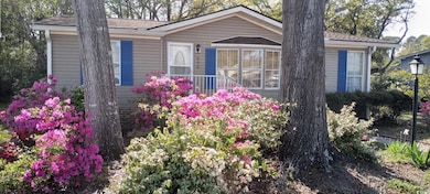 View of side of home with roof with shingles
