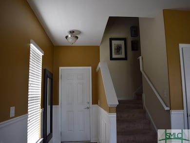 Entranceway.  Picture molding and chair railing