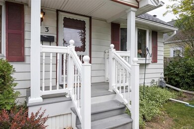 Enter onto a covered front porch.