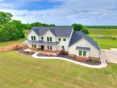 Modern farmhouse featuring a standing seam roof, a