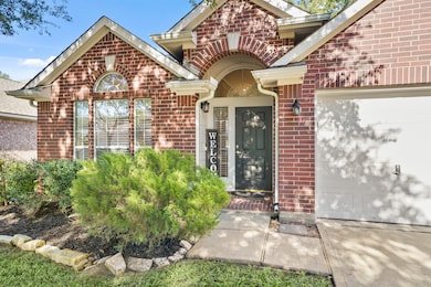 A closer look at the attractive front entry, showcasing the brick archway, covered porch area, and a recently refinished dark front door ready to greet your guests.