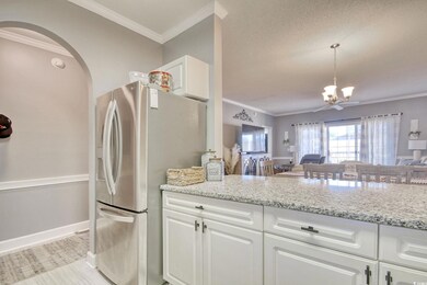 Kitchen featuring light stone countertops, stainle