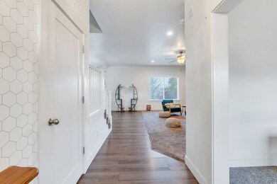 Corridor featuring dark wood finished floors and recessed lighting