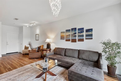 Living room featuring visible vents, wood finished
